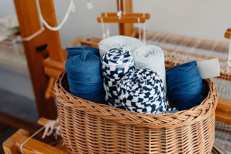 A person's hands skillfully weaving a basket underwater, highlighting the unique and unexpected skills that can be mastered through online learning.